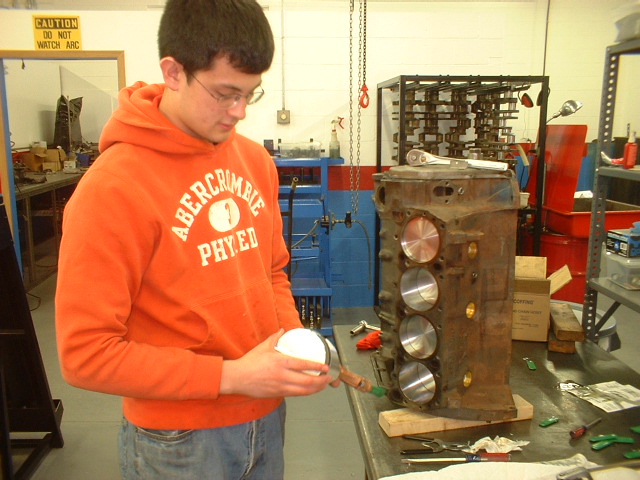 Kevin's positioning the piston rings before installation